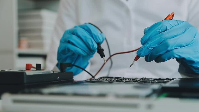 Debugging electronics device. PCB witch microcontroller in electronics laboratory