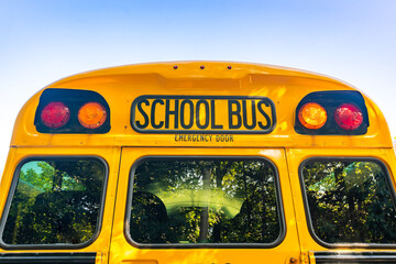 rear of a parked yellow school bus