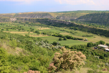 Fototapeta na wymiar View of the valley between the hills in Old Orhei archaeological park, Trebujeni commune, Moldova