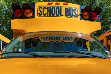 Front of a parked yellow school bus 