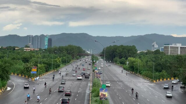 Aerial view of Islamabad after rain and many vehicles are driving on the highway. Traffic on Islamabad highway, Beautiful view of Faisal Avenue with cloudy sky, Islamabad Pakistan 16 August 2023.