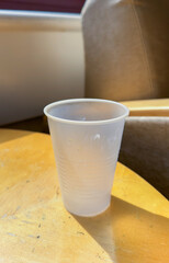 plastic cup amidst nature's beauty symbolizes environmental challenges: recycle, reduce waste, go green for a sustainable future