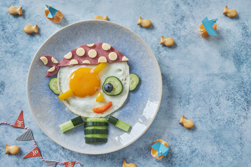 Funny pirate fried egg with ham and vegetable