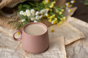 Obraz na płótnie Canvas Cup of cappuccino with milk or cacao and wildflowers
