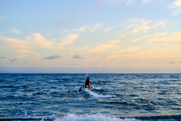 ride a jet ski on the beach, sunset over the sea, sunset in the sea, sea and sky, sunset over sea,...