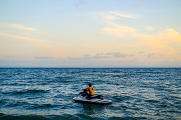 ride a jet ski on the beach, sunset over the sea, sunset in the sea, sea and sky, sunset over sea, beautiful sunset sky, blue and orange sky, sunset wallpaper