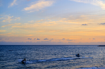 Fototapeta premium ride a jet ski on the beach, sunset over the sea, sunset in the sea, sea and sky, sunset over sea, beautiful sunset sky, blue and orange sky, sunset wallpaper