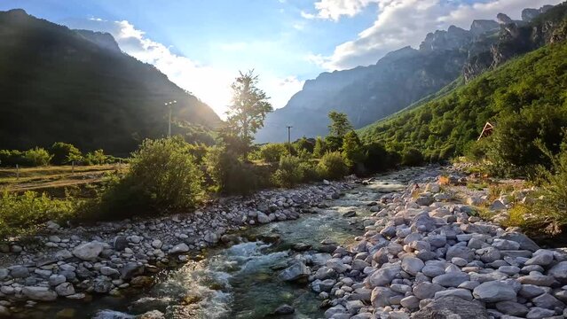 Sunset on the red bridge above the turquoise water river of Valbona valley, Theth national park, Albanian Alps, Albania