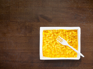 Ready to eat macaroni and cheese microwave dinner and plastic fork