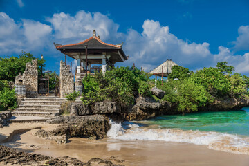 Tropical beach with hinduism temple in Nusa Dua.