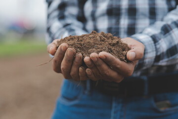 Symbol heart earth day. Handful of dirt hands heart shape. Farm organic earth. Farmer hands soil...