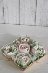 Homemade marshmallows in paper gift boxes. Zephyr flowers.
