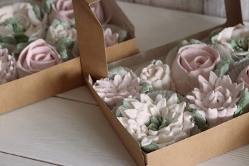Marshmallow flowers on trays. Homemade zephyr. Close-up.