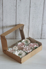 Homemade marshmallows in a paper gift box. Zephyr flowers. Close-up.