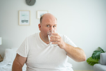 Healthcare Moment: Caucasian Man Takes Medication and Hydrates with Water.