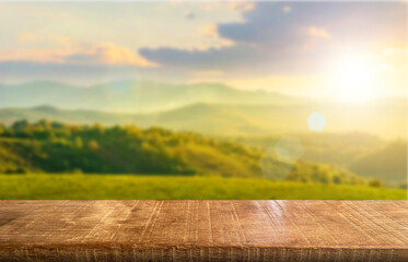 Wooden table top on blur mountain and grass field.Fresh and Relax concept.For montage product display or design key visual layout.View of copy space.