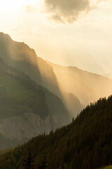 Hazy Sunset View of The Swiss Alps with Mountains in the background in Switzerland in Summer