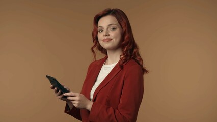 Medium isolated shot of a satisfied, happy and active young woman holding a folder, planchette in her hands and smiling at the camera.