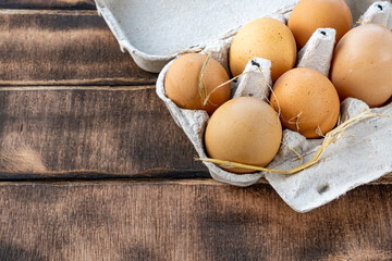 Homemade chicken eggs, brown eggs in a paper container, fresh chicken eggs in a container close-up