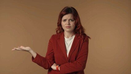 Medium isolated shot of an angry and dissatisfied young woman emotionally looking at the camera,...