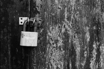 Old rusty lock on metal doors. Lock on the door with an empty place for an inscription