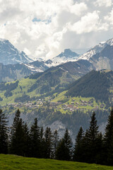 Swiss Alps in Switzerland in the Summer with Mountains Peaking Through Clouds in the Background