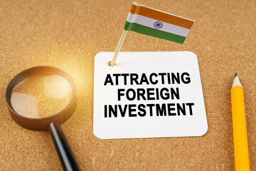 On the table is the flag of India and a sheet of paper with the inscription - attracting foreign investment