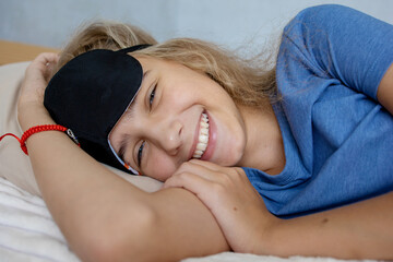 portrait of a teenage girl in a sleep mask. Happy smile and good mood
