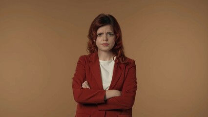 Medium isolated shot of an angry and dissatisfied young woman nervously looking at the camera,...