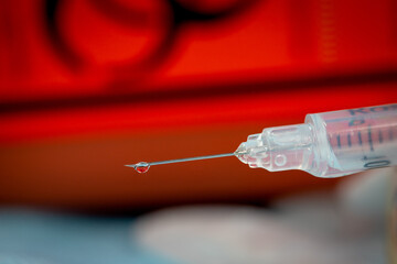 Syringe with drop inside is a biohazard symbol