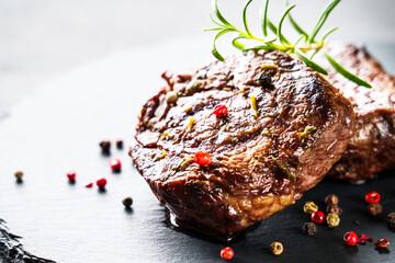 Meat steaks. Filet mignon with spices and herbs at stone board. Close up with copy space.