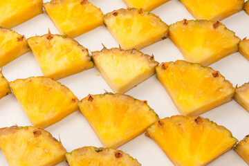 Pineapple juicy yellow slices on a white background.