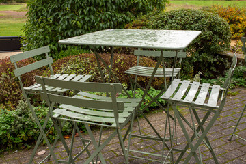 wet coffee table chairs heavy rain autumn