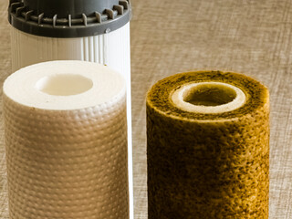 Used water filters with traces of dirt, clay and impurities and clean filters, prepared for...