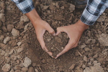 Symbol heart earth day. Handful of dirt hands heart shape. Farm organic earth. Farmer hands soil...