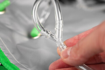 Pneumatic transparent tube splitter. Plastic connector in hand
