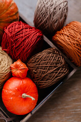 Cotton thread and pumpkin in a wooden egg. Beautiful autumn background