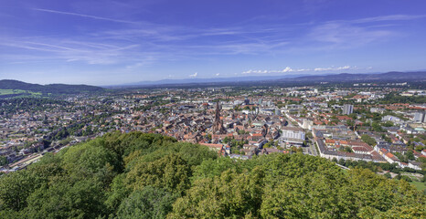 Obraz premium Freiburg im Breisgau. View over the roofs of the old town with Freiburg Cathedral. Baden-Wuerttemberg, Germany, Europe