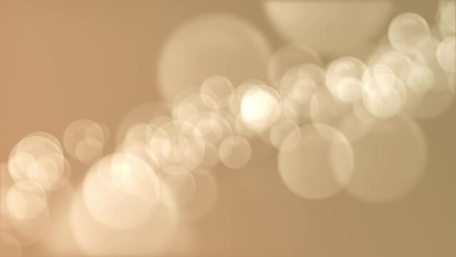 Defocused golden bokeh lights background. This elegant motion background animation with lens blur bokeh sphere particles is full HD and a seamless loop.