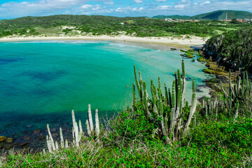 Top view of the beautiful beach of Conchas, close to the city of Cabo Frio, with white sand beaches, vegetation around, sea with clean waters and in shades - 125