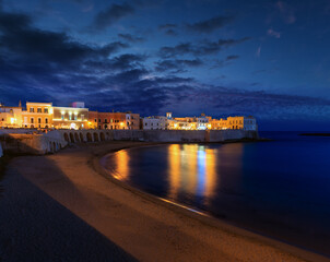 Evening dusk in Gallipoli, province of Lecce, Puglia, southern Italy.  View from walls of...
