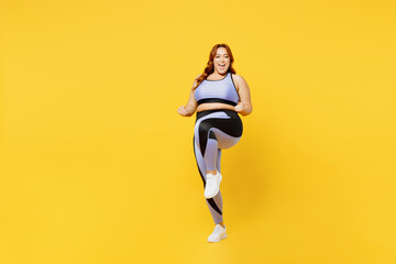 Fototapeta na wymiar Full body overjoyed excited happy young chubby plus size big fat fit woman wear blue top warm up training do winner gesture isolated on plain yellow background studio home gym. Workout sport concept.