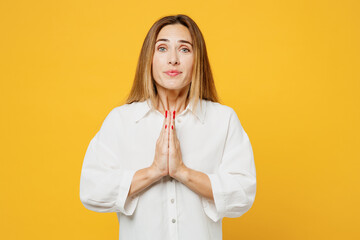 Young caucasian happy woman she wearing white shirt casual clothes hold hands folded in prayer...