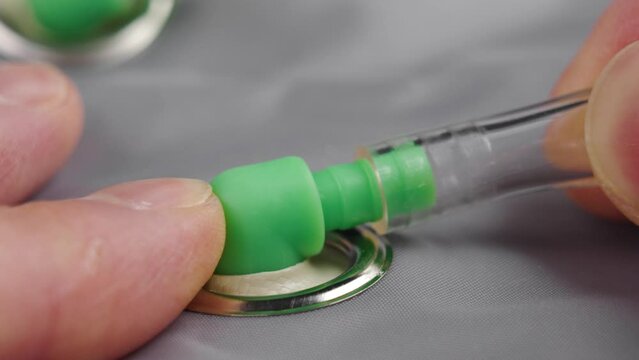 Connecting a pneumatic transparent tube to a plastic connector close up