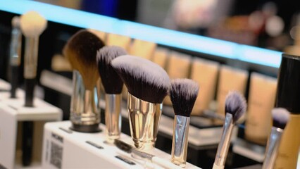 Various makeup brushes in a beauty salon or cosmetics store, close-up