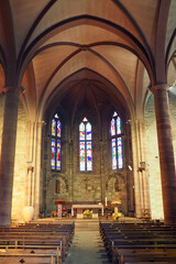Fototapeta na wymiar Nave and choir of the Notre-Dame du Bout du Pont church in Saint Jean Pied de Port, in the Basque country. The church which overlooks the banks of the Nive is integrated into the city wall