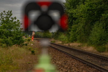 Surveyors with instruments on railway track near green forest in south Bohemia