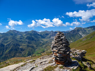 Selected focus of cairns of stones with scenic view of mountain landscape with a rocky terrain near...