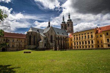 Premonstratensian Monastery, Beautiful Historic Building with Church in Sunlight, Green Lawn in Front, Dramatic Stormy Clouds in the Sky