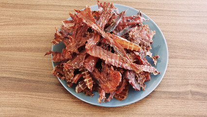 Ready-made homemade chicken slices in a dehydrator. Jerky. Close-up